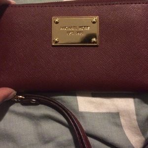 Authentic Michael Kors Wristlet in cinnabar.
