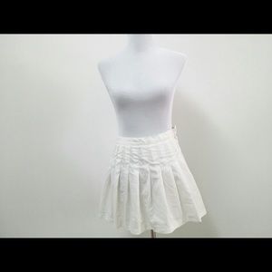 Playing tennis in white skirt