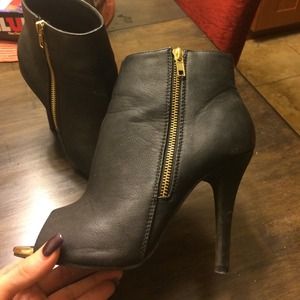 Black leather ankle boots with gold zipper