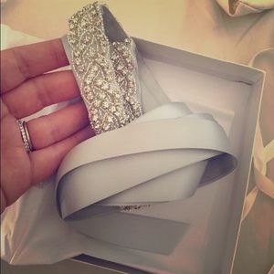 Two light silver wedding belts.