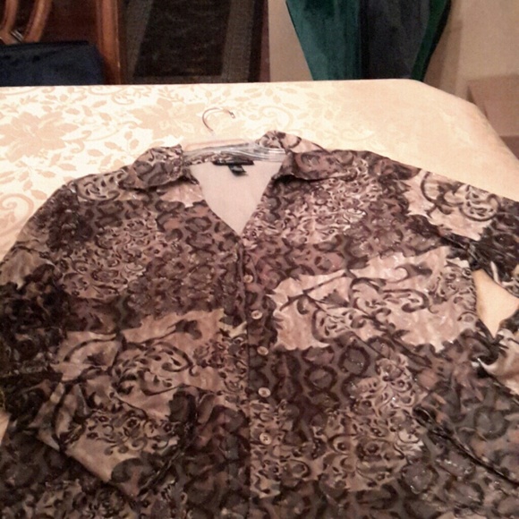 A new tan and brown netted  long sleeve blouse.