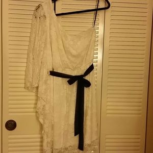 White dress with black sasch, and black leggings.