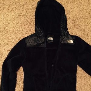 Women's black North Face jacket with hood.