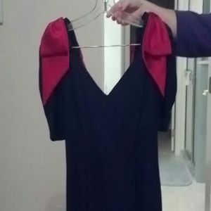 Black cocktail dress with red bows on shoulders