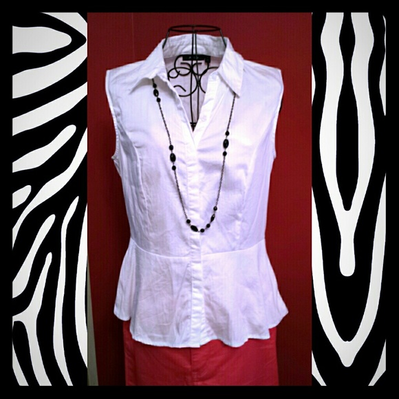 White sleeveless trumpet waistband blouse.