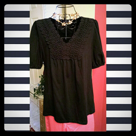 Black top with black eyelet lace embellishment.