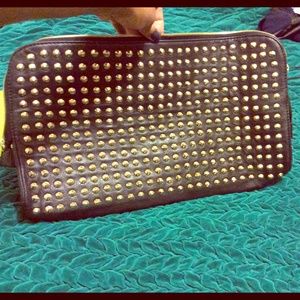 Oversized gold studded leather clutch