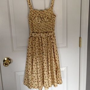 Vintage-ish yellow sundress with floral detail.