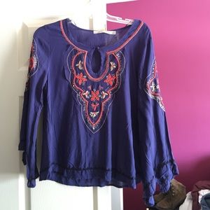 A beautiful flowy shirt, dark purple with decals!
