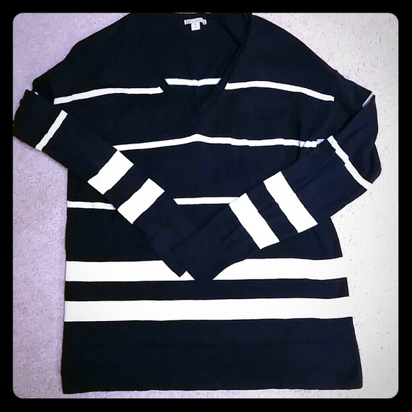 Navy blue and cream striped v-neck sweater.
