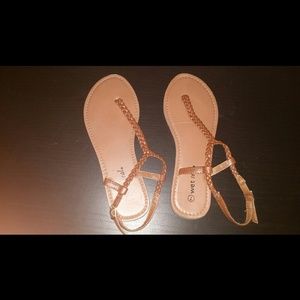 Brown strapped sandals.