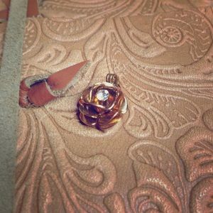 Vintage 14k gold rose charm with diamond center.