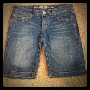 Dark wash Bermuda shorts.