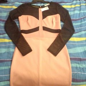 Nude with black mesh cut outs. Long sleeved.