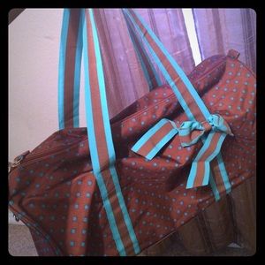 Brown duffle bag with blue polka dots