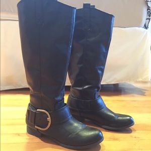 Tall black boots with gold buckle