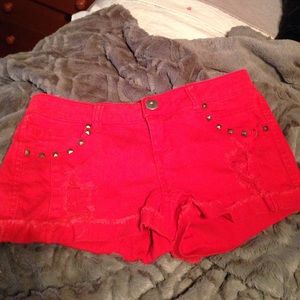 Red denim shorts with studs