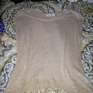 Tan shirt with fringe at the bottom