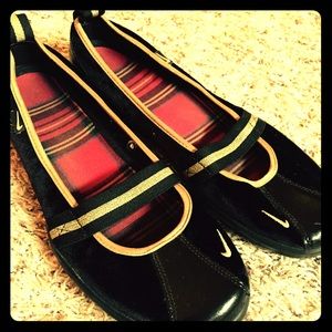 Black with gold accents Nike flats