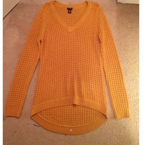 Mustard colored knitted sweater.