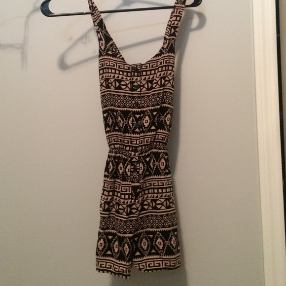 a romper. aztec symbols on it. is brown and black