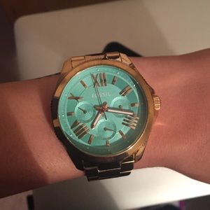 Gold with Aqua face Fossil watch.