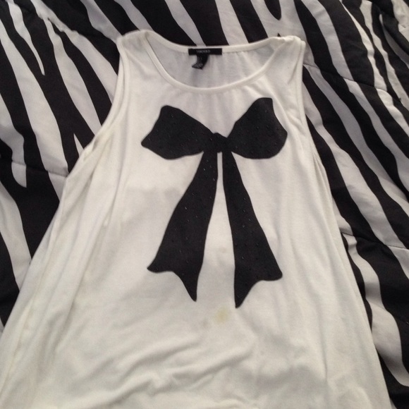 A white sleeveless top with a black bow