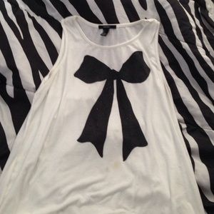 A white sleeveless top with a black bow