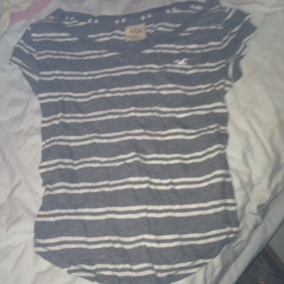 Grey v-neck with white stripes.