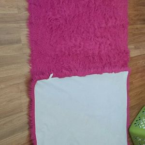 Two pink fuzzy rugs