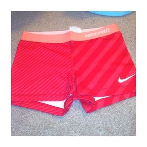 Red/Coral striped Nike Pro's.