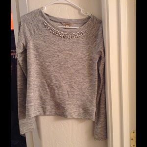 A grey beaded long sleeve top