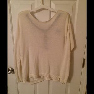 Cream knit sweater with black harness backing.