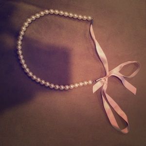 Cute strand of pearls (not real) with pink bow