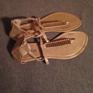 A pair of gold sandals size 11