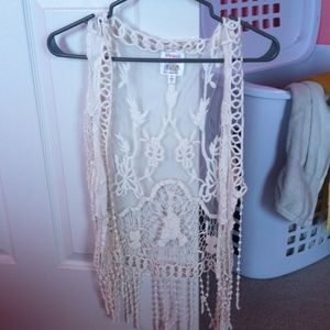Lace sleeveless cardigan with tassels.