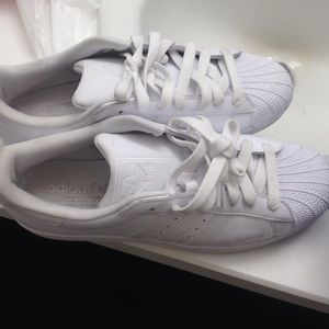 All white shell toe Adidas.