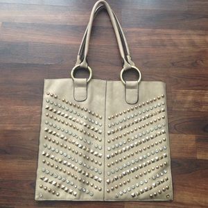 Tan leather purse with designs on the front