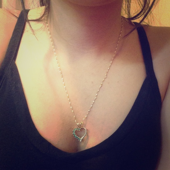 Gold necklace with green diamonds.
