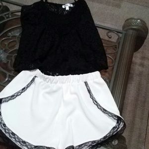 White short shorts with black lace trimming