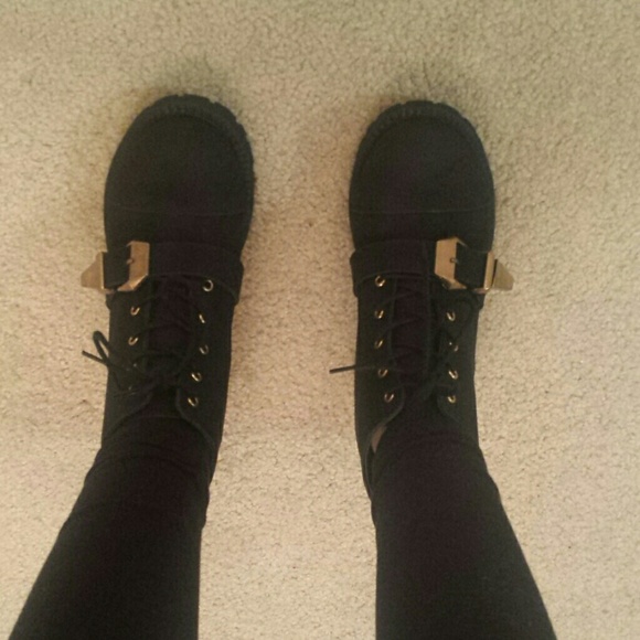 Black boots with gold tone buckle