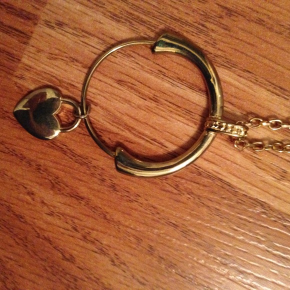 Gold-tone necklace with heart on a charm holder