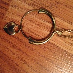 Gold-tone necklace with heart on a charm holder