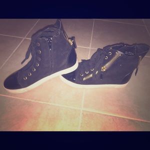 Black high top style sneakers with gold zippers