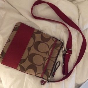 Red and brown Coach crossbody bag.