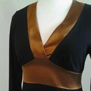 Black knit top with copper satin trim and tie.