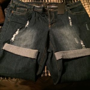A dark distressed pair of capris