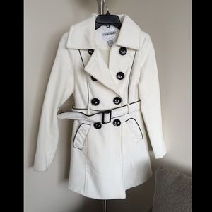 White fleece coat with black lining.