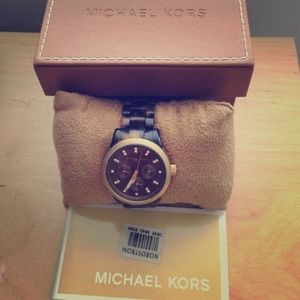 Michael kors tortoise shell watch with gold trim.
