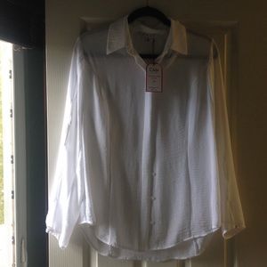 white blouse, button up with openings on sleeves.